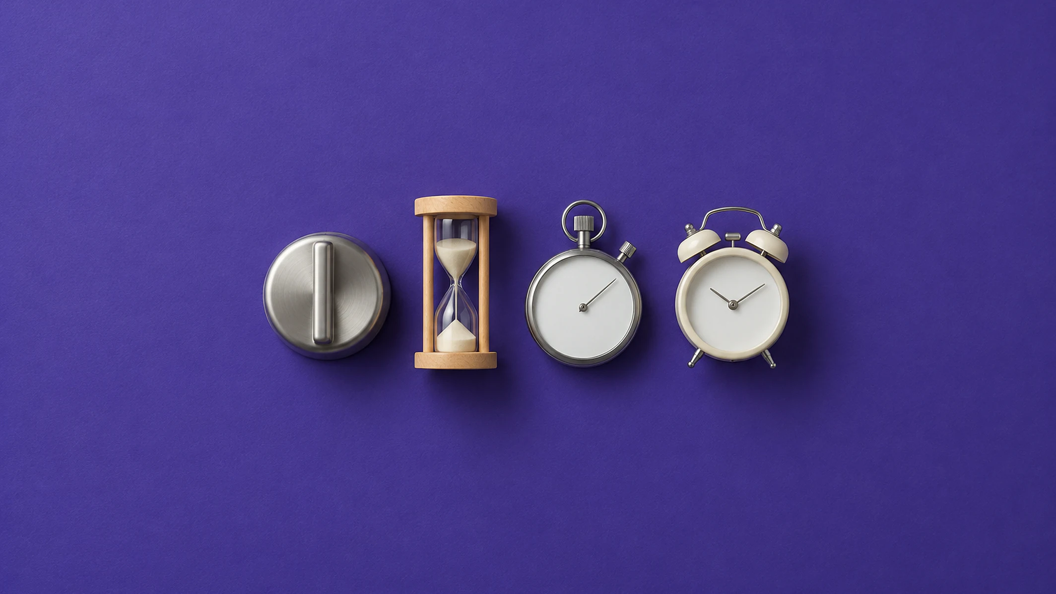 Timer de cozinha de metal, ampulheta de madeira, cronômetro e despertador lado a lado, sobre papel violeta
